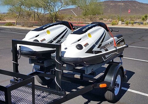 Two Yamaha SuperJet personal watercraft on a trailer