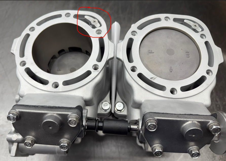 A sacrificial anode (circled) mounted on a PWC cylinder head assembly